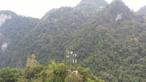 Communication base stations and antennas on a mountain top in karst terrain