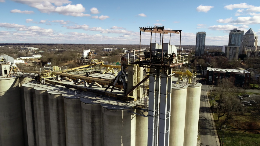Down Town Charlotte North Carolina city landscape aerial Helicopter view of the buildings in the metropolitan areas at sunset cloudy but textured blue sky showcasing major development and construction