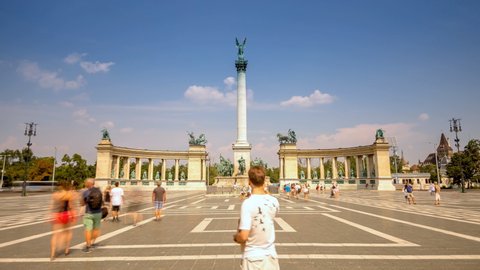 Budapest heroes square, Tourists walking and sightseeing at the famous Heroes Square in Budapest on warm sunny day. Motion Time Lapse scene Budapest, Hungary. 