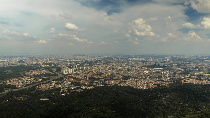 4K UHD Panoramic wide angle timelapse of Sao Paulo cityscape from Jaragua peak. Moving clouds and sunlight of urban landscape of Brazil