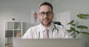 Doctor talking to a patient via internet. Professional healthcare service worker consulting the patient remotely, speaking in video chat 4k footage