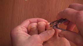 4K Close up Cutting toenails with a metal clipper
