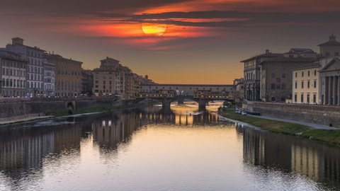 Florence skyline aerial view, Ponte Vecchio Florence zoom Timelapse at night and Arno river in Florence Italy City. Reflection on water. Footage in 4K.