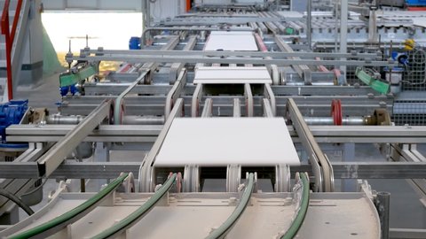 Production factory line of ceramic tiles. Conveyor belt system. Modern heavy plant