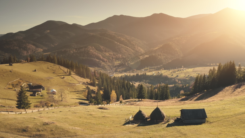Burnt grass fields at Alps mountain village aerial. Nobody nature landscape. Cottages at countryside farmlands. Mountaineering vacation. Sun spruce forest. Travel to Alpine mounts, Switzerland, Europe | Shutterstock HD Video #1068147221