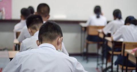 Asian high school students in white school uniform are serious and tired of exams.