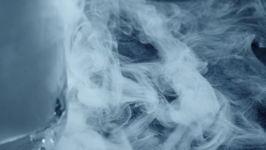 Curling low temperature steam and cold dry ice or frozen carbon dioxide. Cryogenic technology related slow motion shot Royalty-Free Stock Footage #1068179321