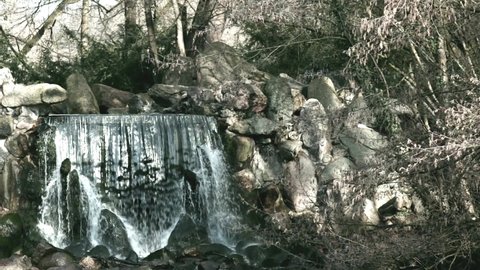 Small waterfall with rocks in the Sonsbeek park in Arnhem in the Netherlands