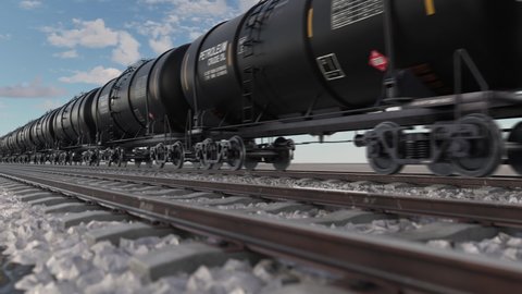 Cistern petroleum train with crude oil moving fast on railroad. Oil industry and diesel fuel transportation for heavy industrial and technology needs. Close up view to railway and tank wagons.