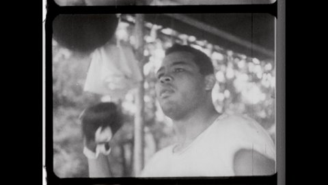 1930s Detroit, MI. Professional Boxer Joe Louis, aka The Brown Bomber, punching a speed bag. 4K Overscan of Vintage Archival 16mm Film Print. 