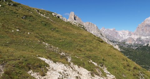 Summer Landscape in the Mountains, Aerial Mountain View, Flying above Hills and meadows toward Steep Rocky Mountain. Outdoor Activities, Sports, Hiking and Rock Climbing in the Alps and Dolomites 4K