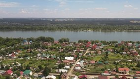 Aerial video of suburban settlement near siberian river Ob and town Novosibirsk. Siberia, Russia