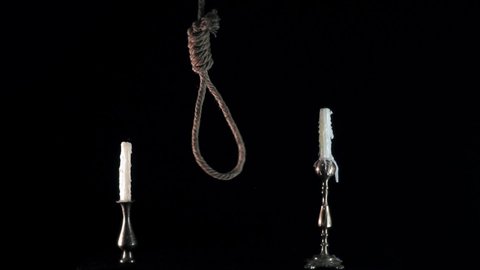 suicide loop and candles. suicide concept. свечи гаснут в момент смерти. Rope noose with hangman knot in front of dark background. suicide loop
