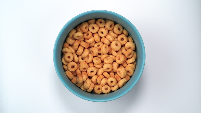 Milk being poured into a bowl of cereal
