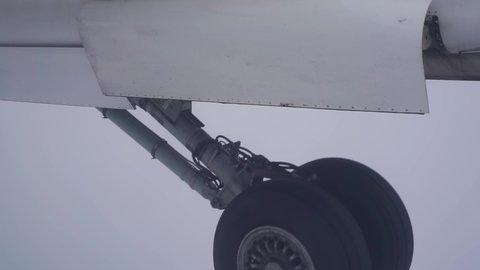 Airplane landing gear down deploy flying in dense fog zero visibility instrument flight approach for landing. Aviation industry
