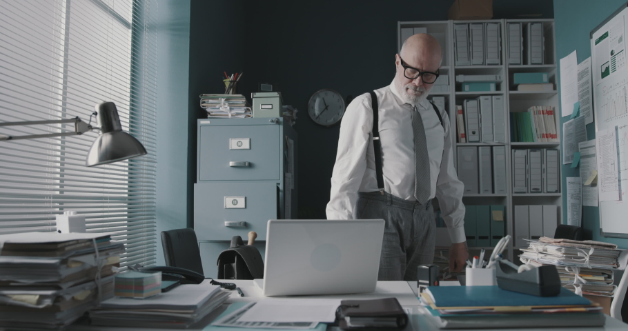 Stressed angry businessman smashing his laptop with a baseball bat, job burnout concept | Shutterstock HD Video #1068224981