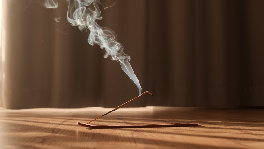 Burning aromatic incense smoky stick for meditation and relaxing. Aromatherapy smoke for yoga concept. | Shutterstock HD Video #1068226937