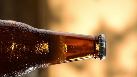 vertical footage of cold beer bottle cap opening