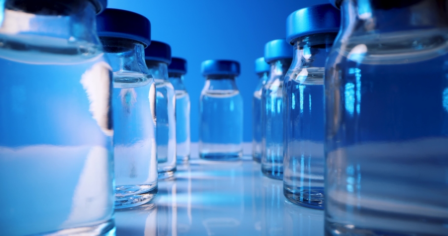 Vaccine bottles closeup. sliding between blank medical injection vials | Shutterstock HD Video #1068230234