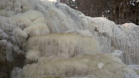 Close-up 4k footage of a beautiful frozen waterfall in winter