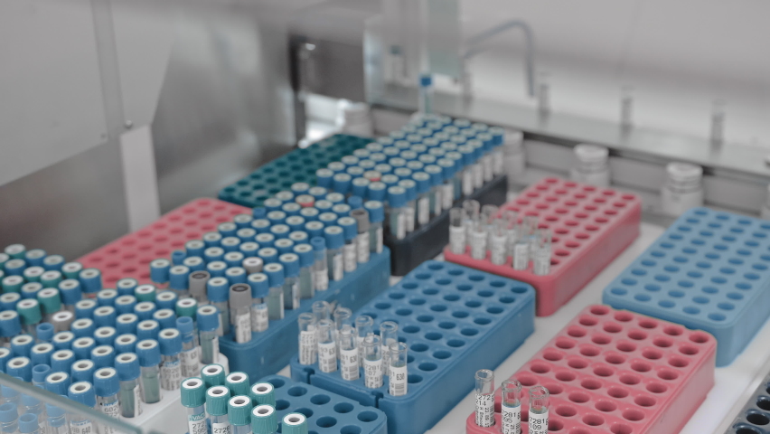 Automated production of vaccines and medicines, development and testing in laboratory, vaccine trials, concept. Test tubes on pharmaceutical conveyor, sorting with modern robotic technology Royalty-Free Stock Footage #1068231689