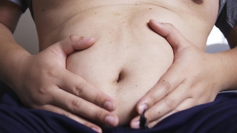 Man is pressing his hand on his stomach due to persistent abdominal pain