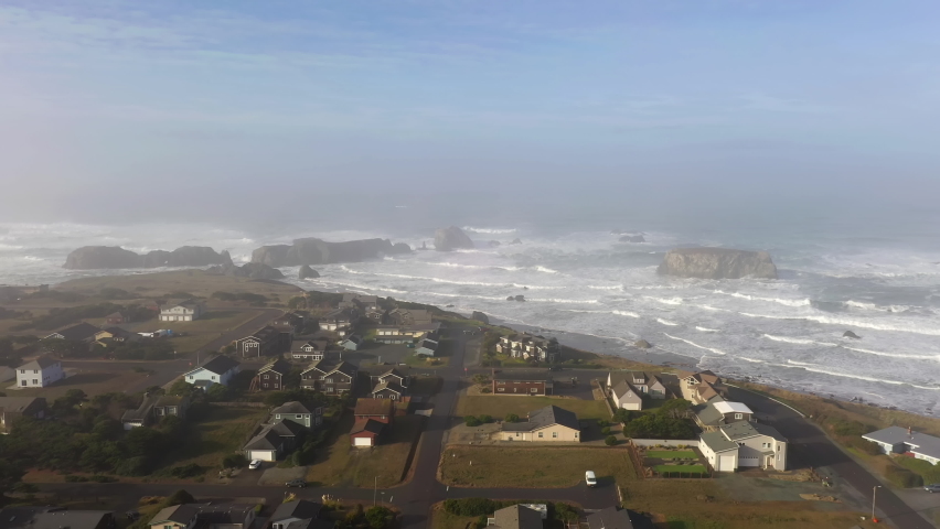 Aerial flying towards sea stacks in foggy day. Bandon, Oregon