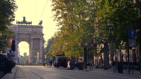 MILAN, ITALY - SEPTEMBER 2019: Famous vintage tram in the centre of the Old Town of Milan in the sunny day, Lombardia, Italy. Arch of Peace, or Arco della Pace on the background.