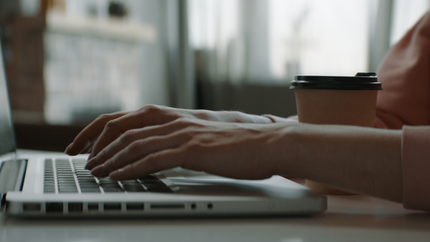 CU Caucasian female working from home, spills coffee on keyboard of her laptop. Shot with 2x anamorphic lens Royalty-Free Stock Footage #1068255281
