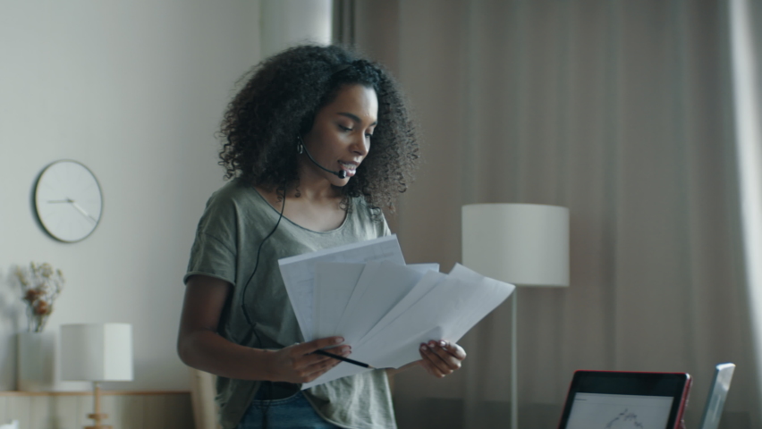 MED Black African American female working from home, having a phone call with client or office. WFH, stay home, COVID-19 coronavirus pandemic new normal concept Royalty-Free Stock Footage #1068255347