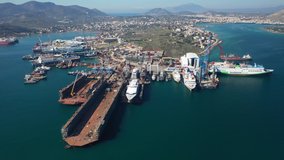 Aerial drone rotational video of shipyard in old port of Salamina island place where historic battle of Salamina took place, Attica, Greece
