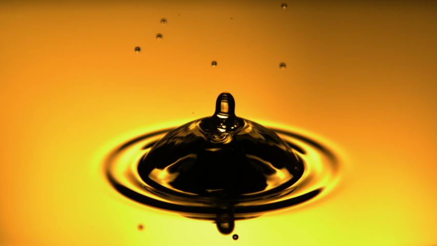 Oil Drop Falling in Slow Motion with Yellow Backlit Background a Macro Shot. | Shutterstock HD Video #1068260681