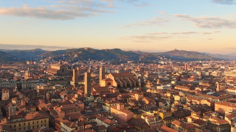 bologna skyline aerial view drone flying backwards over city center,italian town cityscape at dawn shot at sunrise