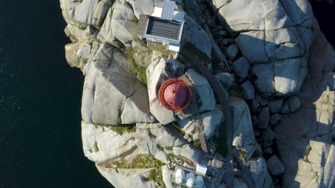 Svenner Lighthouse on Norwegian coast island, birds eye drone footage rotate above the lighthouse