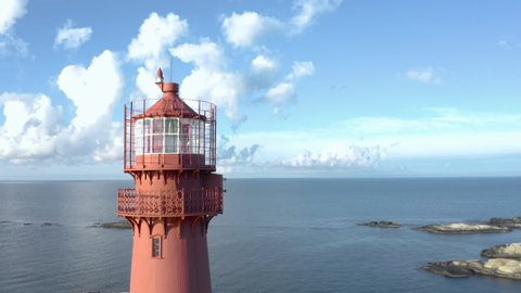 Lighthouse close up, Svenner Lighthouse on Norwegian coast island, drone footage orbit the red tower