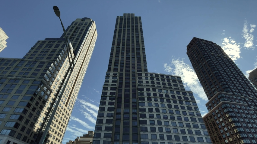 NYC, USA - FEB 25, 2021: driving past tall skyscrapers on Manhattan West Side Riverside Boulevard in New York City.