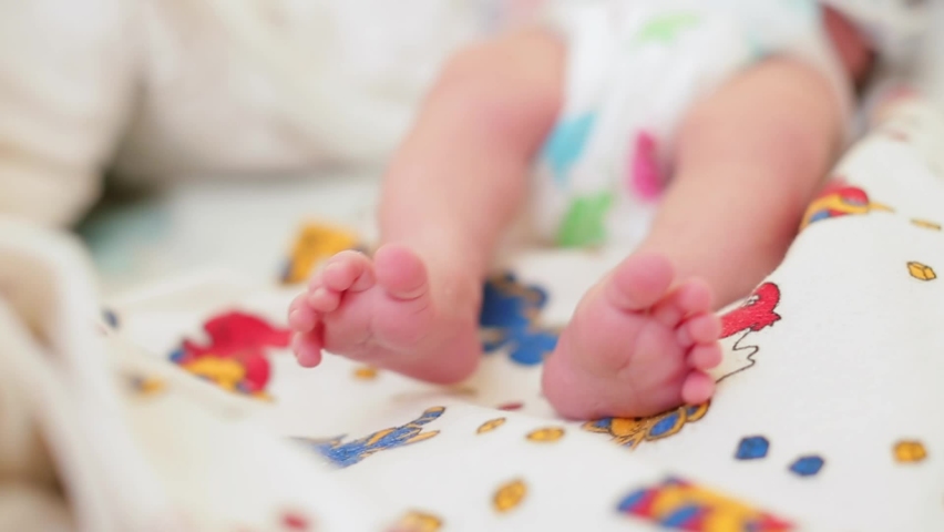 Feet of newborn baby in motion signify early stages of motor development and exploration in world. Newborns well-being sensitive to changes in temperature, cozy and warm environment. Early Childhood Royalty-Free Stock Footage #1068273452