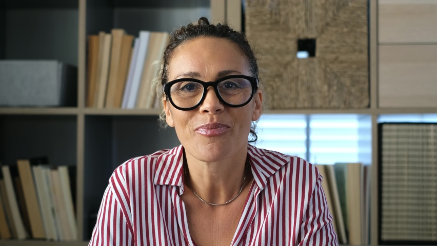 Portrait and close up of one old woman talking to the camera in video conference or call. Headshot of female person at home in the office working
 | Shutterstock HD Video #1068274409