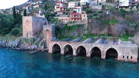Alanya old ancient shipyard. Haven of pirate vessels in ancient times. Mediterranean coast. Aerial drone footage. 4k video. Calm weather in mediterranean coast. 