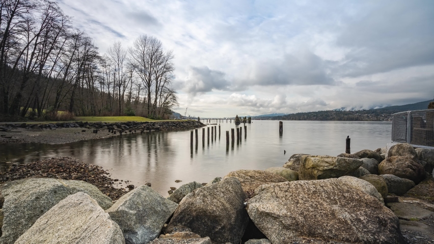 People walking in park with lake and mountain view in Canada
