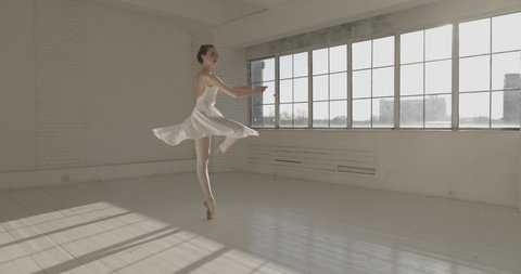 Young caucasian ballet dancer performing in studio. Choreographer spinning around herself, training before going on stage. Arts concept 4k footage