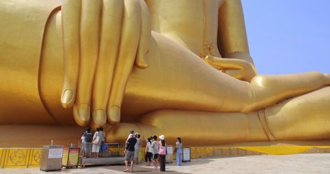 Ang-Thong, Thailand - Feb 2021 : Golden big Buddha at Wat Muang located in Ang-Thong province, Thailand. People come to pay respect to the large golden Buddha statue.