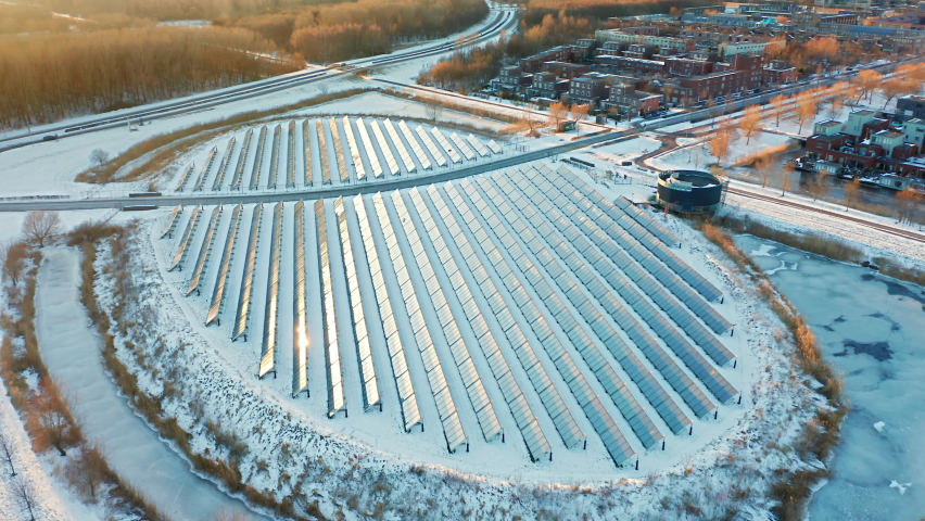Solar panels farm in a modern sustainable neighbourhood in Almere, The Netherlands, in winter. Aerial shot. Royalty-Free Stock Footage #1068285587