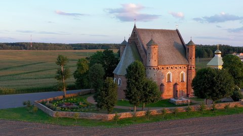 Aerial drone view. A majestic Orthodox church in the village of Synkovichi, Belarus. View from a drone to the Church of St. Michael at sunset.
