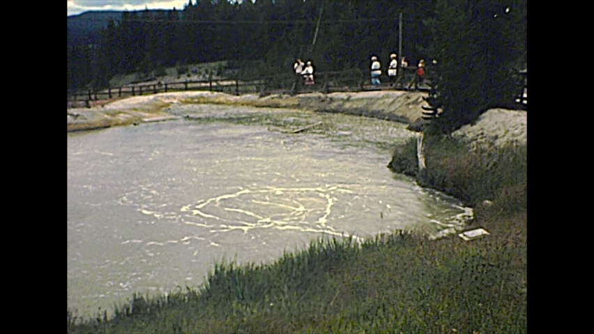1970s hot spring pools with steam in Yellowstone National Park, Wyoming and Montana. United States of America archival in 1977.