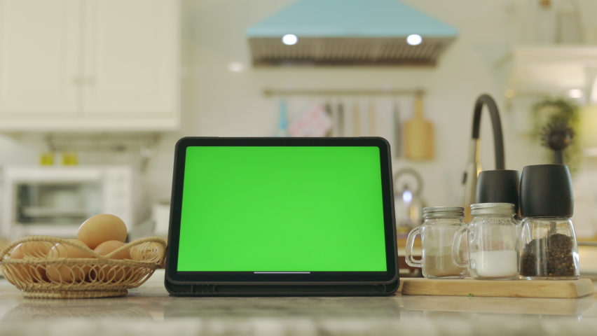 Tablet with green screen chroma key . In kitchen at home. Royalty-Free Stock Footage #1068292232