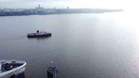 Wirral , Liverpool , United Kingdom (UK) - 02 06 2021: Aerial view following Mersey commuter passenger ferry cruise in shimmering river to Woodside terminal Birkenhead