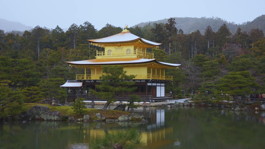 Snow on Rooftops of Kinkakuji temple in Kyoto Japan, Winter Scene.