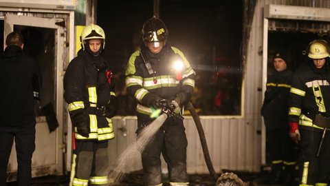 Kyiv, Ukraine - 02.28.2020: a firefighter extinguishes a fire near a burnt-out store