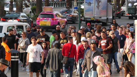 LAS VEGAS, NEVADA USA - 5 MAR 2020: People on pedestrian walkway. Multicultural men and women walking on city promenade. Crowd of citizens on sidewalk. Diversity of multiracial faces in metropolis.